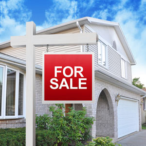 Home with a for sale sign Home with a for sale sign
